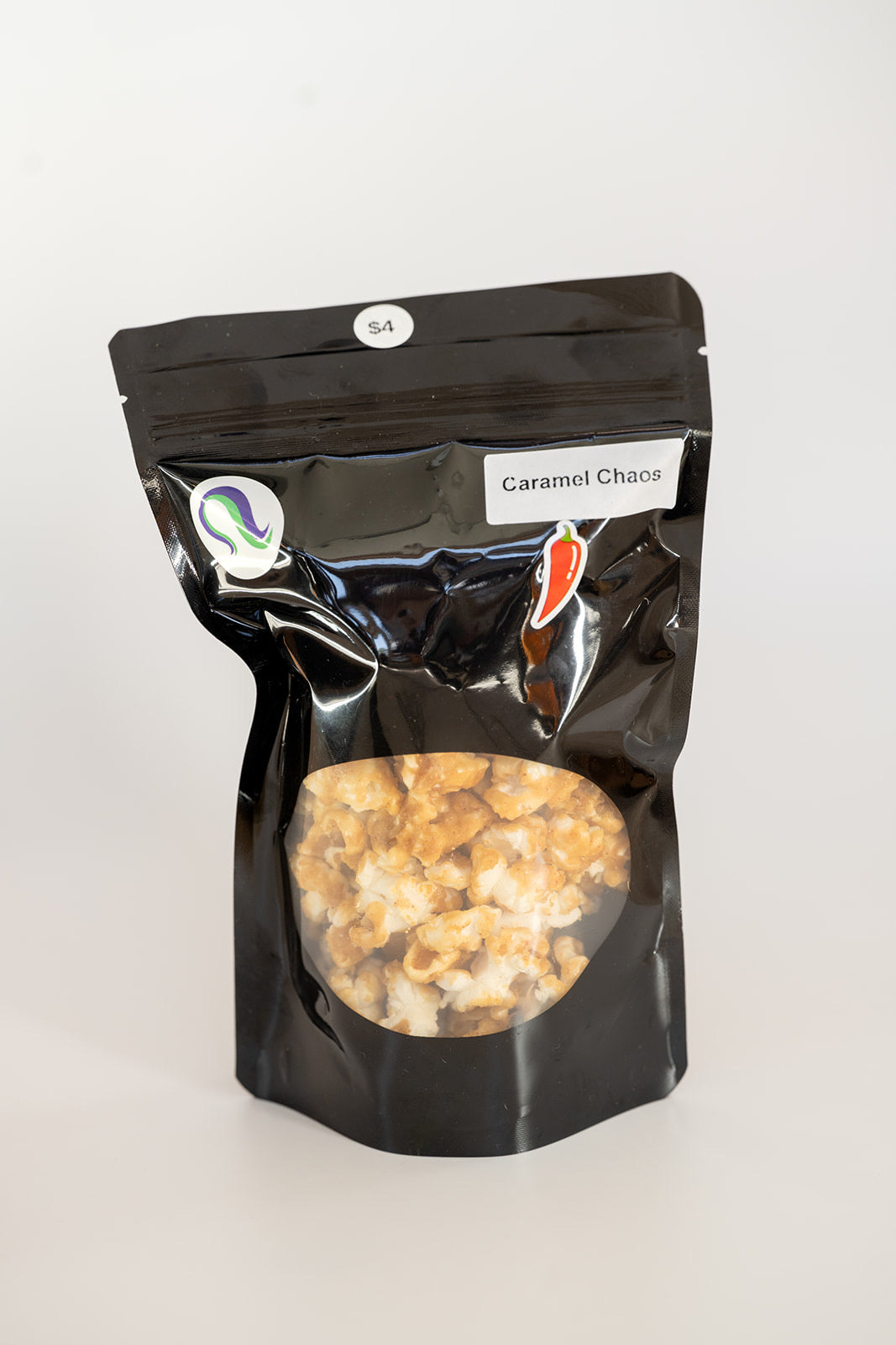 TBC Creations Caramel Chaos spicy popcorn small bag angled view with chili pepper sticker