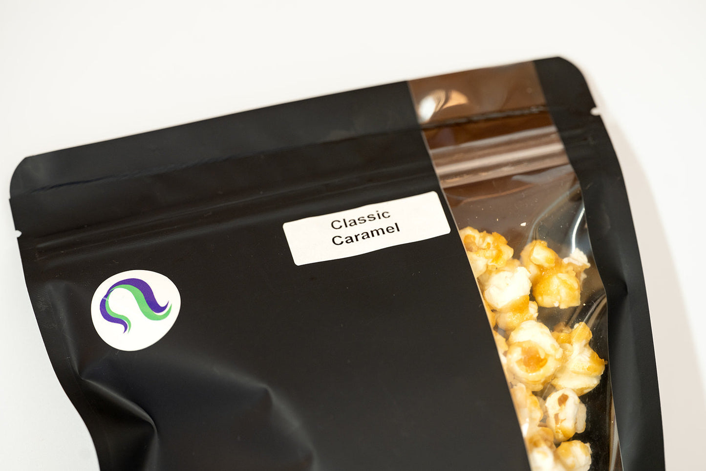 Close-up of TBC Creations Classic Caramel corn bag label and logo