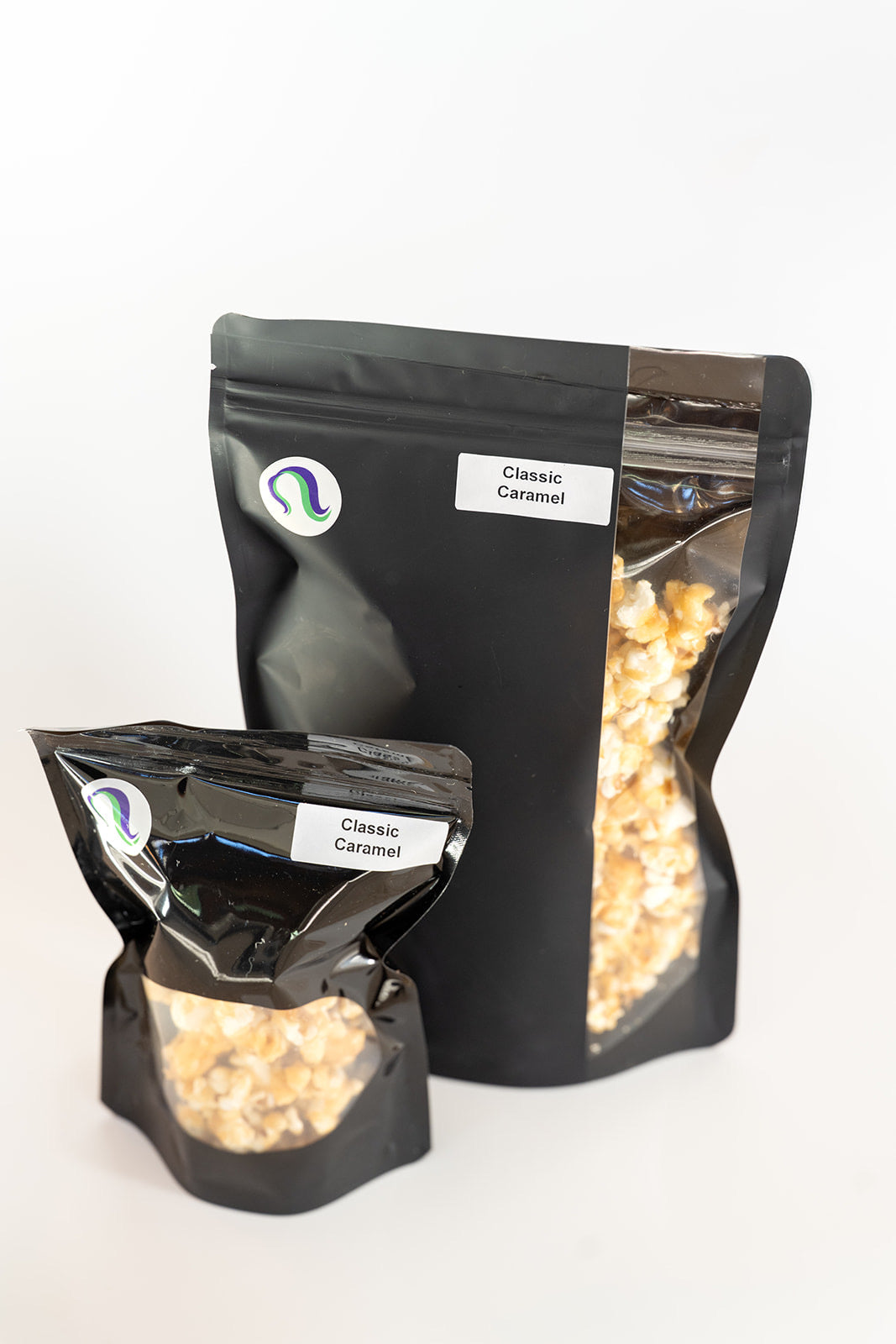 TBC Creations Classic Caramel corn small and large black bags displayed side by side